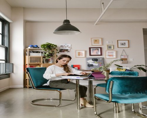 A professional woman working comfortably in a well-lit home office space in Mexico City